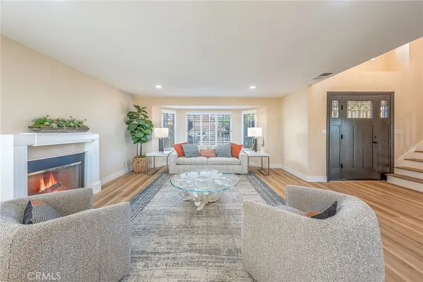 a living room with furniture and a fireplace
