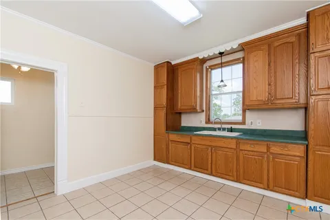 a kitchen with a sink and cabinets