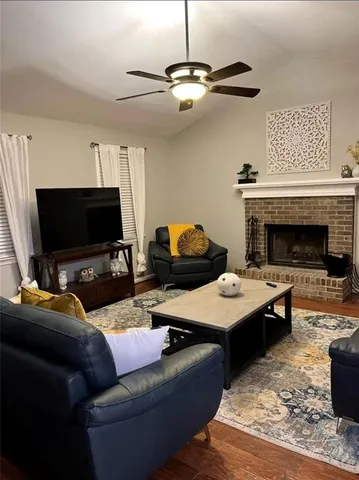 a living room with furniture and a fireplace
