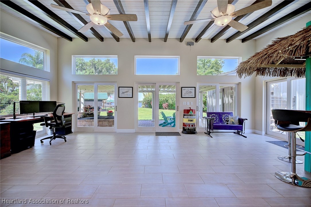 7411 Sparta Road Sebring, FL 33875 - Photo 15 of 50 a view of a living room and livingroom with furniture wooden floor a flat screen tv