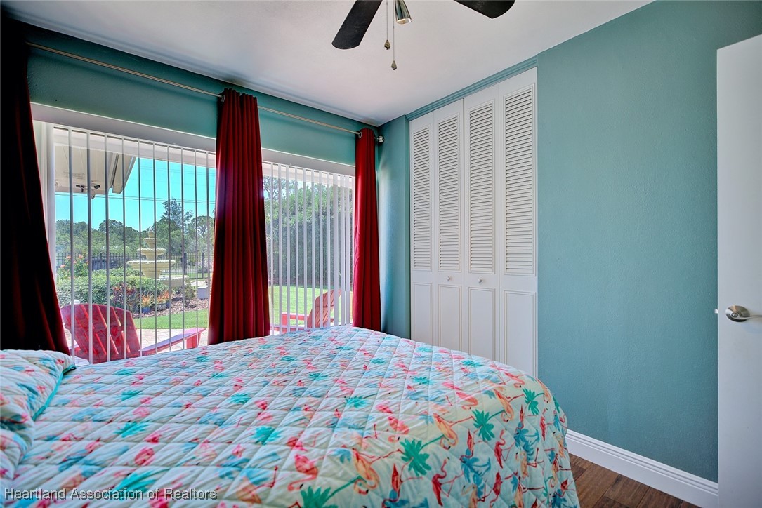 7411 Sparta Road Sebring, FL 33875 - Photo 19 of 50 a bedroom with a bed and a large window