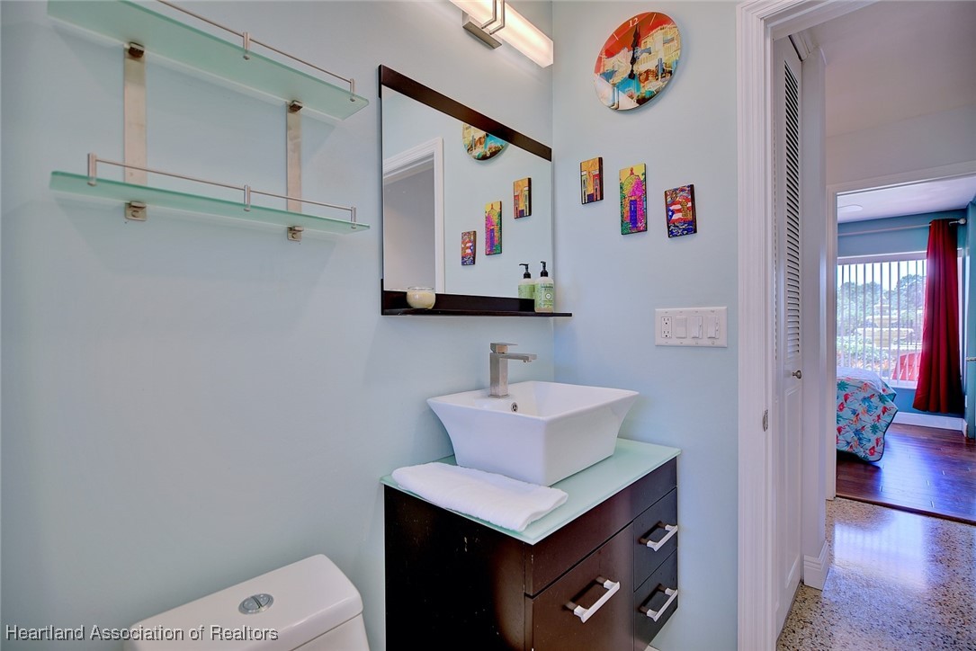 7411 Sparta Road Sebring, FL 33875 - Photo 23 of 50 a bathroom with a sink a mirror and a toilet