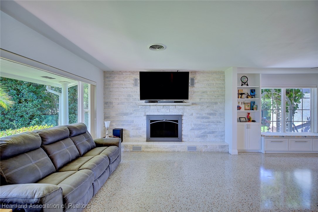 7411 Sparta Road Sebring, FL 33875 - Photo 6 of 50 a living room with fireplace furniture and a flat screen tv