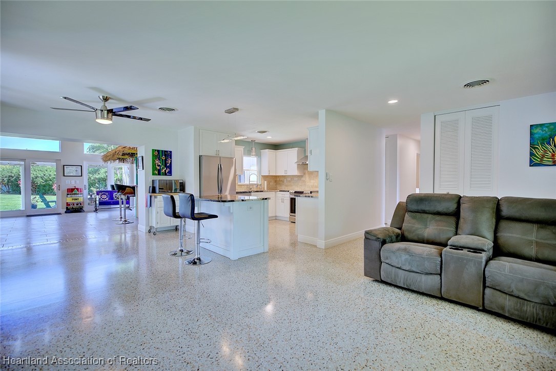 7411 Sparta Road Sebring, FL 33875 - Photo 7 of 50 a living room with furniture and a view of kitchen