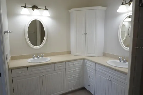 a bathroom with a granite countertop toilet sink and mirror
