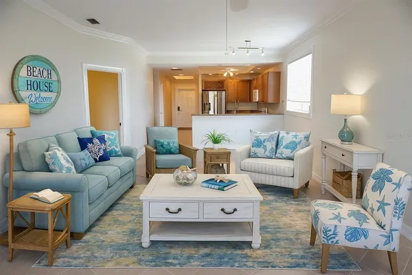 a living room with furniture a clock on wall and a table