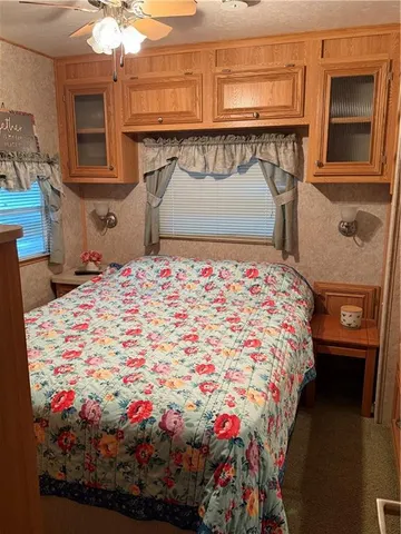 a bed sitting in a bedroom next to a cabinet