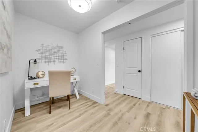 a view of work space with wooden floor and a window