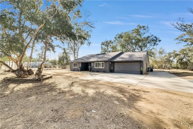 a view of a house with a yard and covered with snow