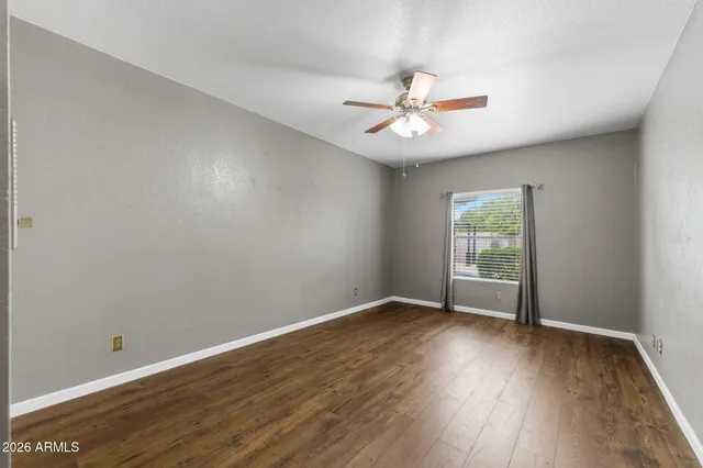 a bathroom with a double vanity sink a large mirror and a bathtub