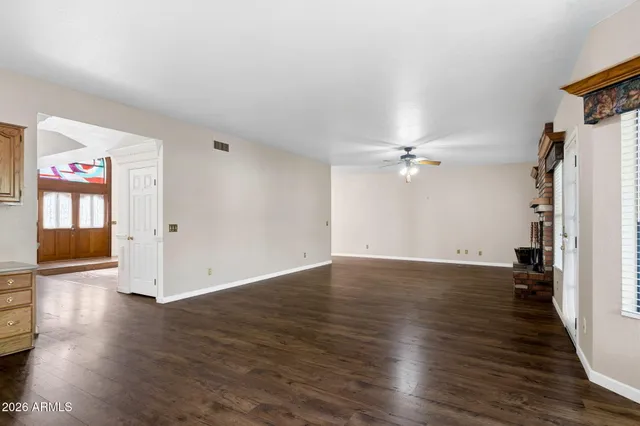 wooden floor in an empty room with a window