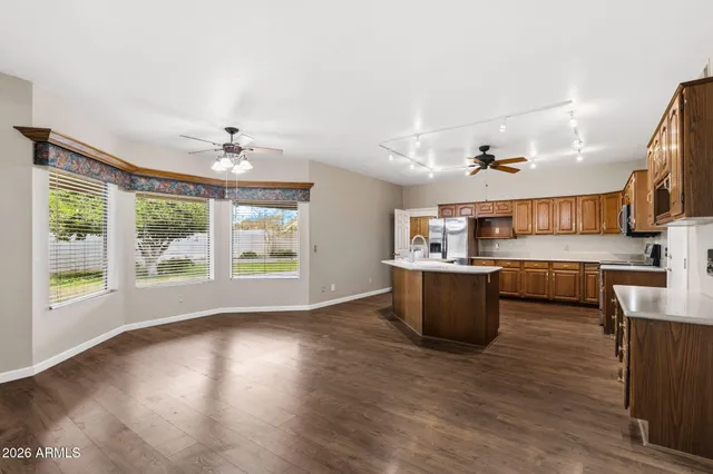 a large kitchen with cabinets and wooden floor
