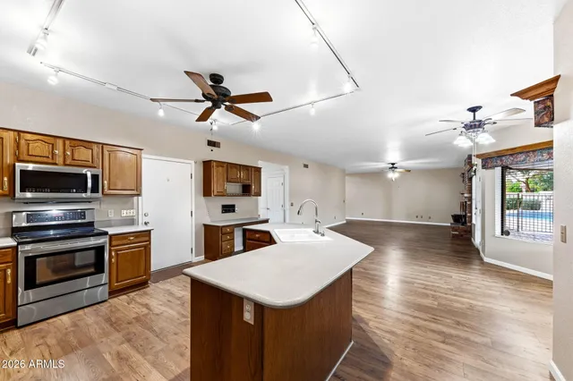 a kitchen with sink cabinets and stainless steel appliances