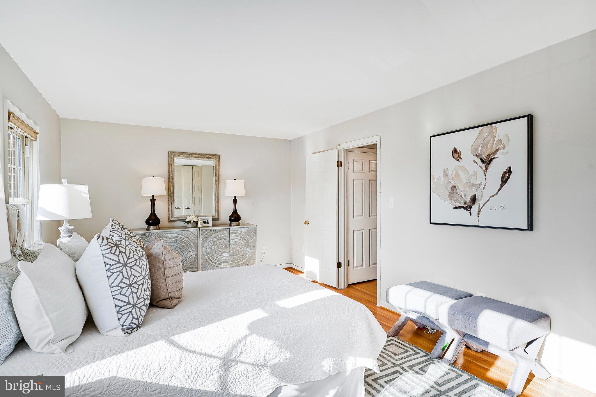 7346 Eldorado Street McLean, VA 22102 - Photo 23 of 48 a bedroom with a large bed and a chandelier