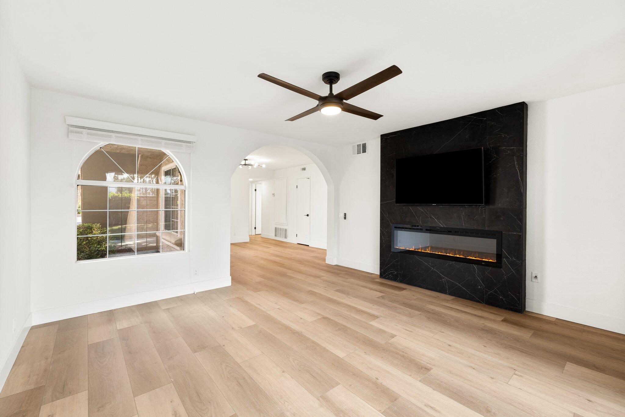 505 South Farrell Drive, Unit A3 Palm Springs, CA 92264 - Photo 13 of 43 a view of empty room with a flat tv screen and a ceiling fan