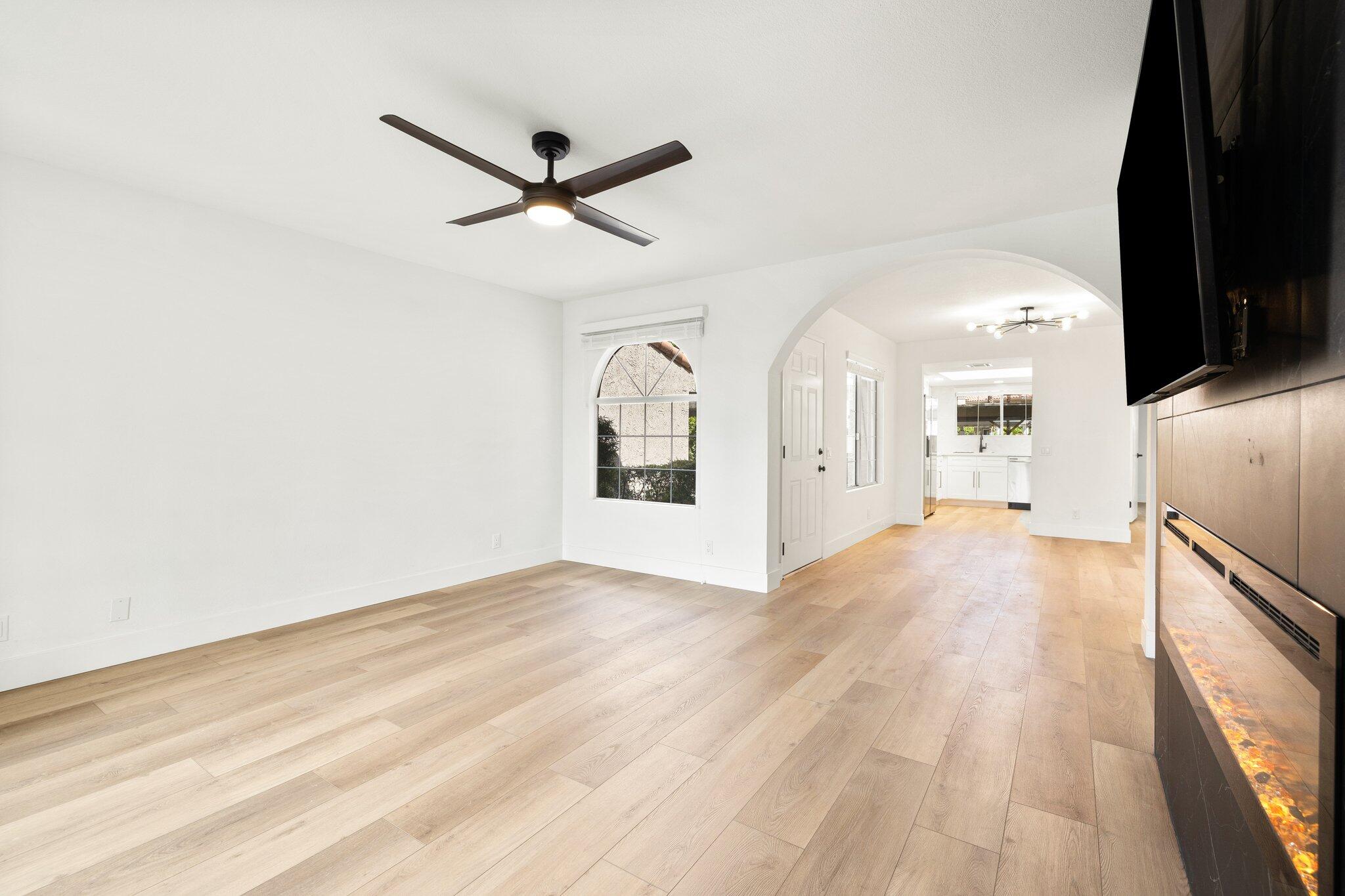 505 South Farrell Drive, Unit A3 Palm Springs, CA 92264 - Photo 14 of 43 a view of a big room with wooden floor a ceiling fan and windows
