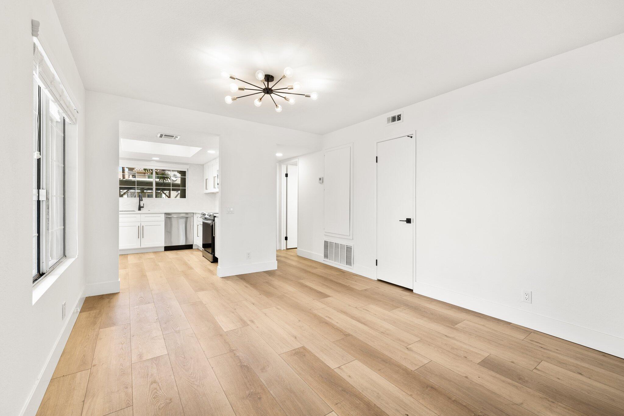 505 South Farrell Drive, Unit A3 Palm Springs, CA 92264 - Photo 15 of 43 a view of an empty room with wooden floor and a ceiling fan