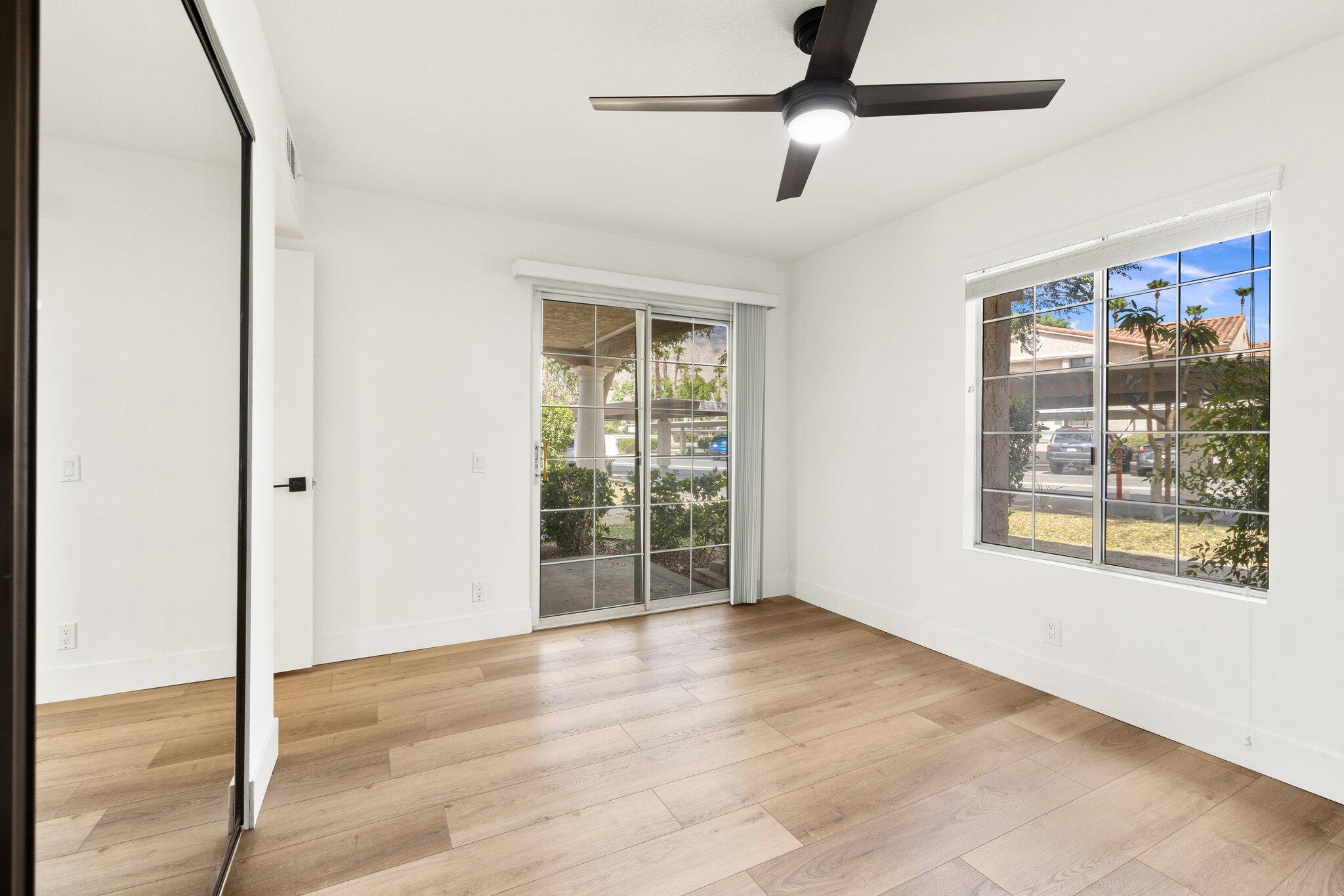 505 South Farrell Drive, Unit A3 Palm Springs, CA 92264 - Photo 18 of 43 a view of an empty room with wooden floor and a window