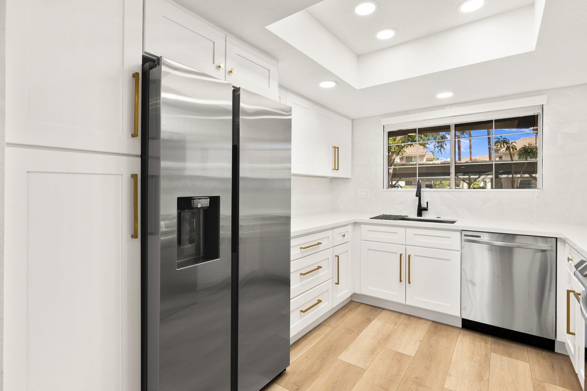 505 South Farrell Drive, Unit A3 Palm Springs, CA 92264 - Photo 20 of 43 a kitchen with stainless steel appliances granite countertop a refrigerator and a sink