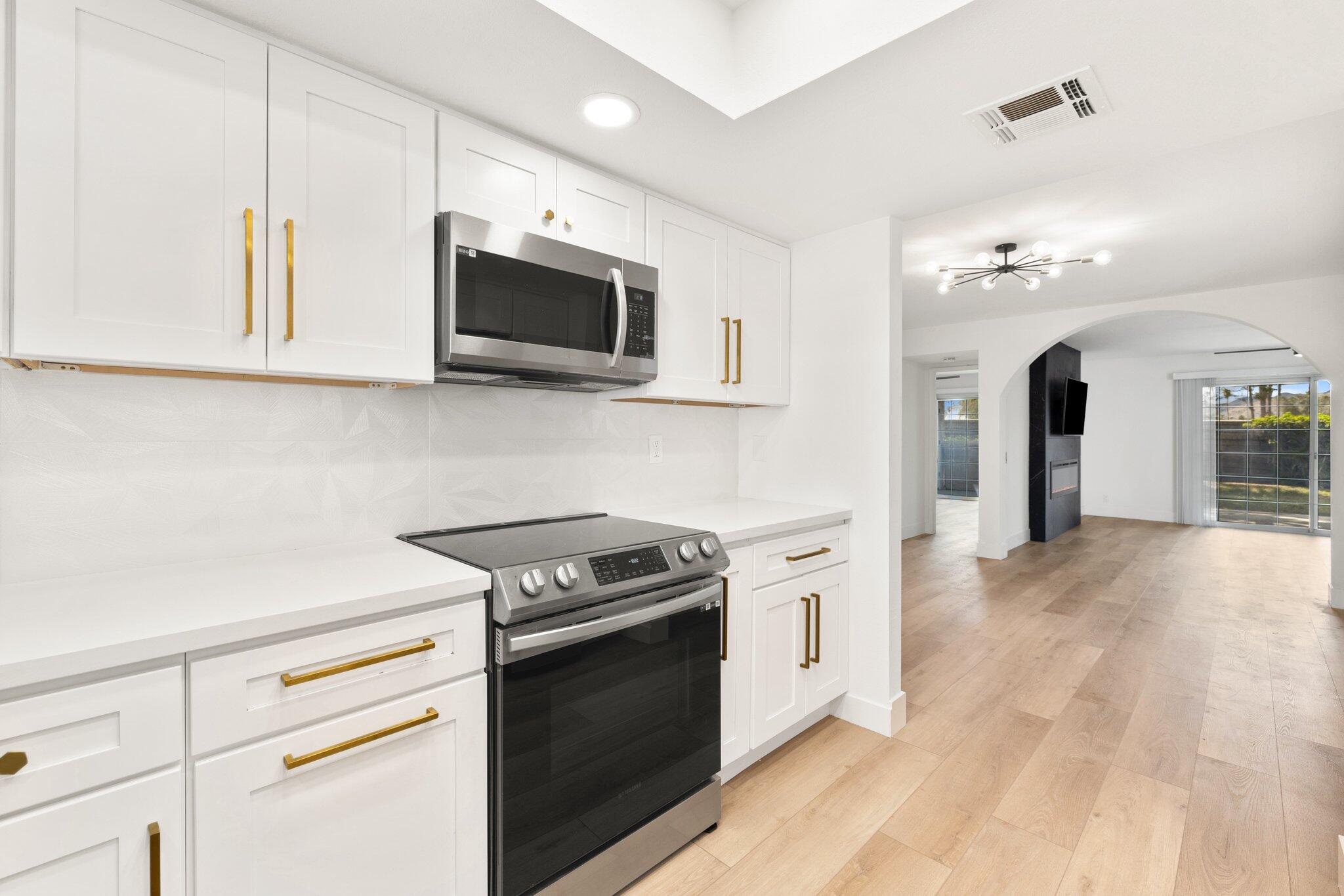 505 South Farrell Drive, Unit A3 Palm Springs, CA 92264 - Photo 22 of 43 a kitchen with stainless steel appliances white cabinets and a stove a oven with white countertops