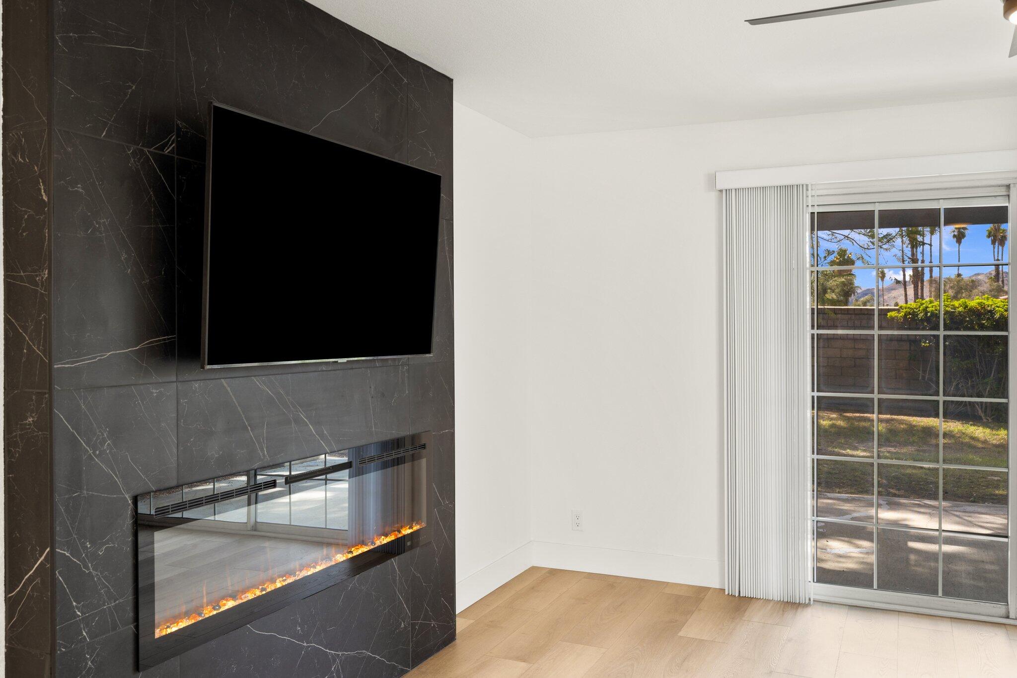 505 South Farrell Drive, Unit A3 Palm Springs, CA 92264 - Photo 32 of 43 a room with wooden floor and a flat screen tv