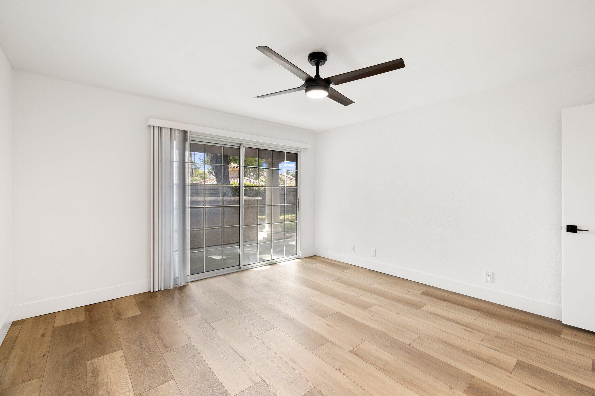 505 South Farrell Drive, Unit A3 Palm Springs, CA 92264 - Photo 8 of 43 an empty room with wooden floor and windows