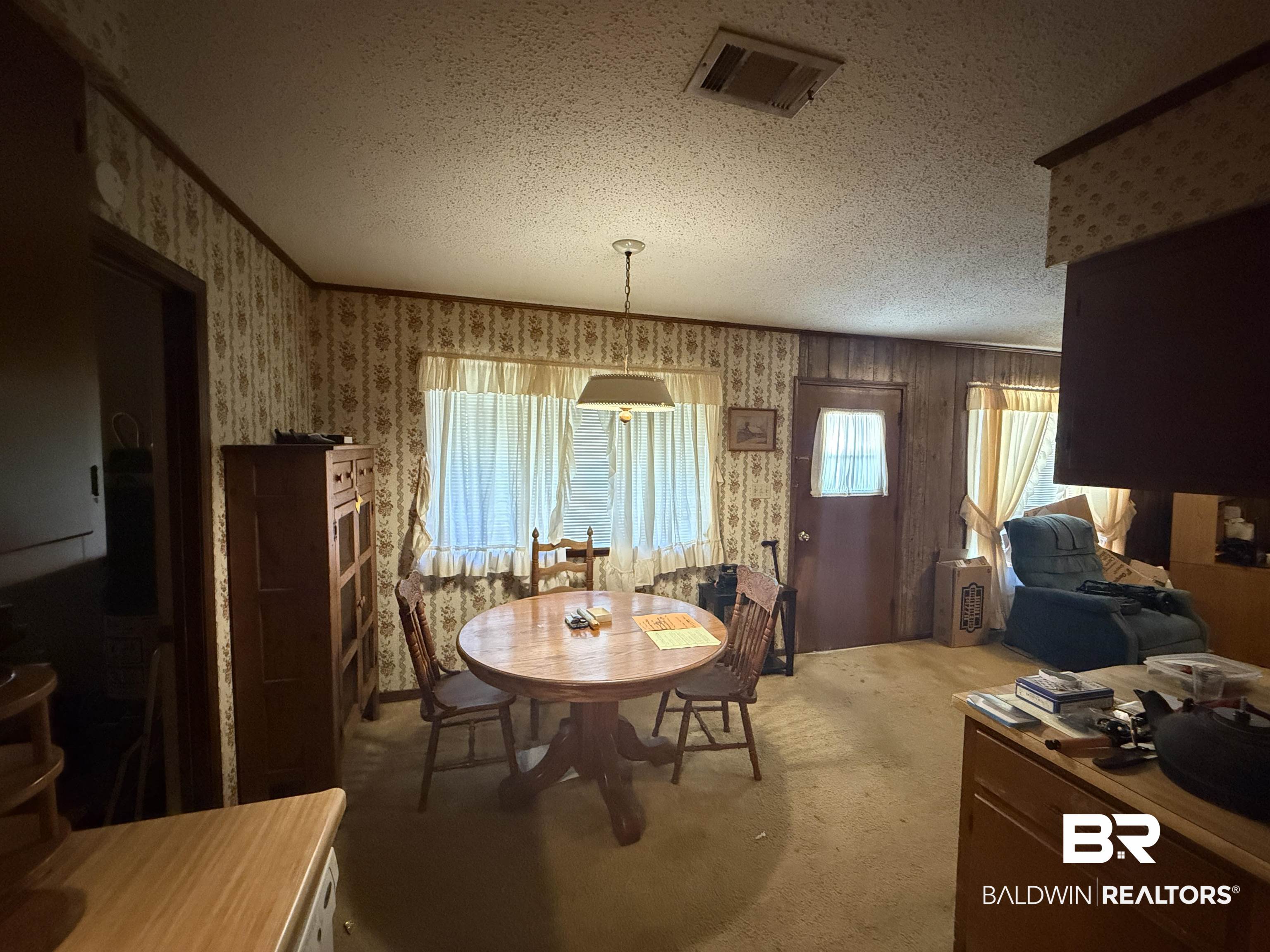 513 Club Wiley Road Jackson, AL 36545 - Photo 5 of 19 Dining space off of kitchen and family room with a textured ceiling, light carpet, and plenty of natural light