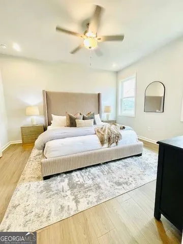 a bedroom with a bed and a flat screen tv