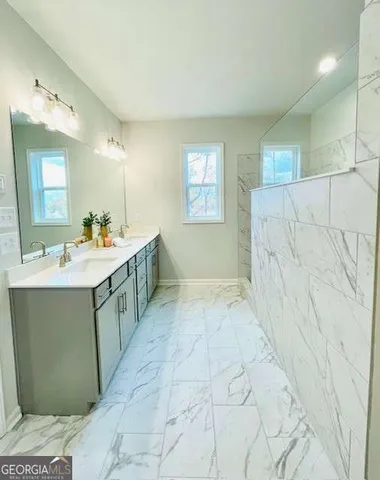 a bathroom with a sink a vanity a mirror and a bathtub