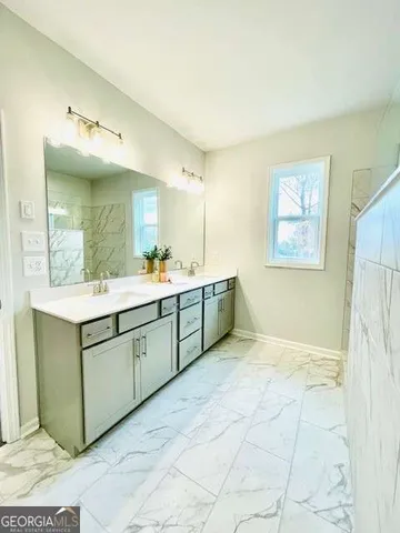 a bathroom with a mirror sink and vanity