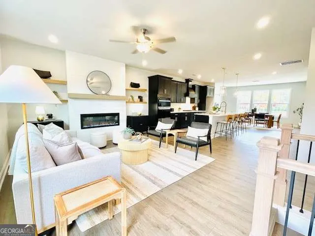 a living room with furniture kitchen view and a fireplace