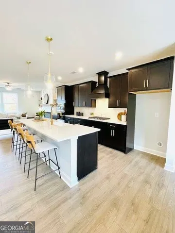 a kitchen with stainless steel appliances kitchen island granite countertop a sink and cabinets