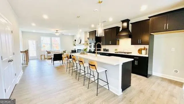 a kitchen with stainless steel appliances kitchen island granite countertop a stove a sink a refrigerator and a refrigerator