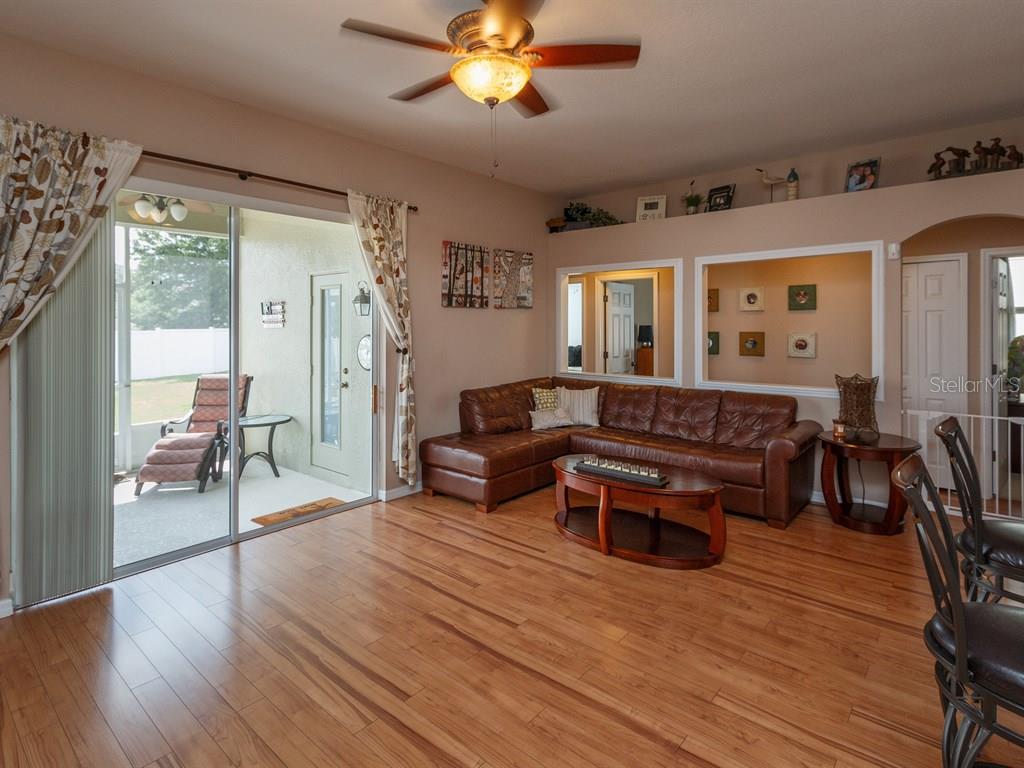 5477 Rishley Run Way Mount Dora, FL 32757 - Photo 10 of 25 a living room with furniture and wooden floor