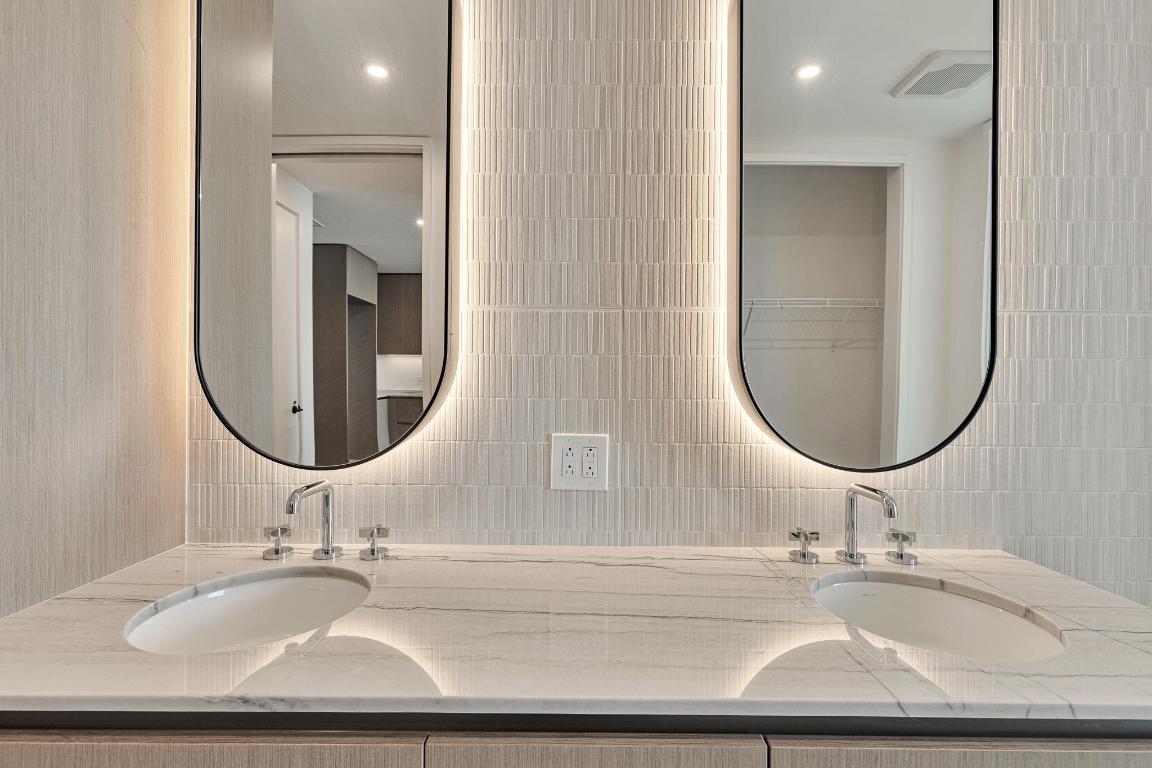 610 Davis Street, Unit 5006 Austin, TX 78701 - Photo 11 of 40 a bathroom with a sink and a mirror