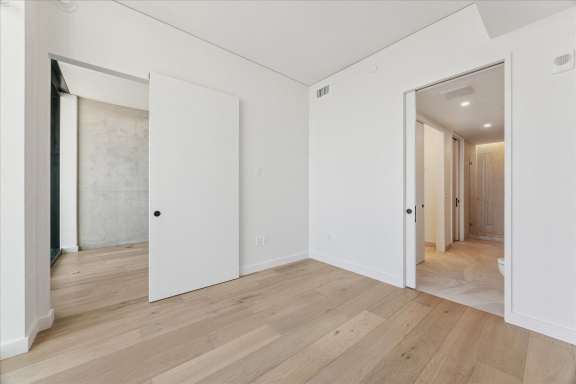 610 Davis Street, Unit 5006 Austin, TX 78701 - Photo 7 of 40 a view of a hallway with wooden floor