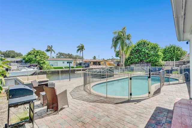 a view of a swimming pool with chairs