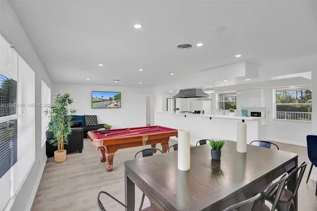 a dining room with furniture and wooden floor