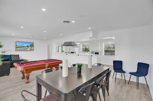 a outdoor dining room with furniture and wooden floor