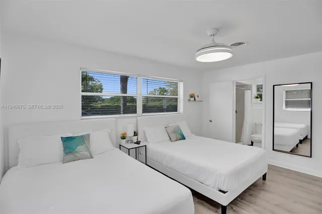 a bedroom with a large bed and a window