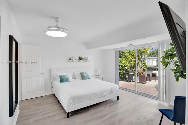 a bedroom with a bed and a large window