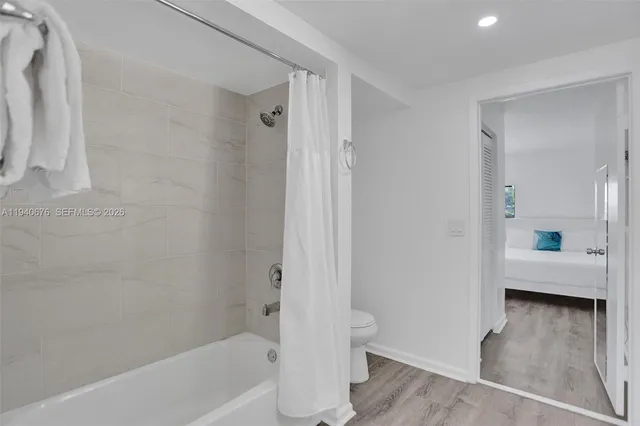 a bathroom with a bathtub and a toilet