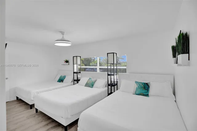 a bedroom with a large bed and a flat screen tv