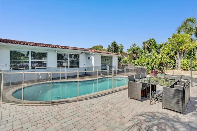 a view of a house with backyard porch and sitting area