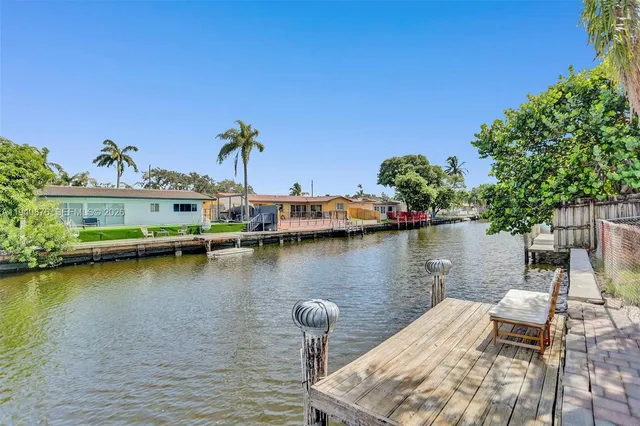 a view of a lake with boats and palm trees