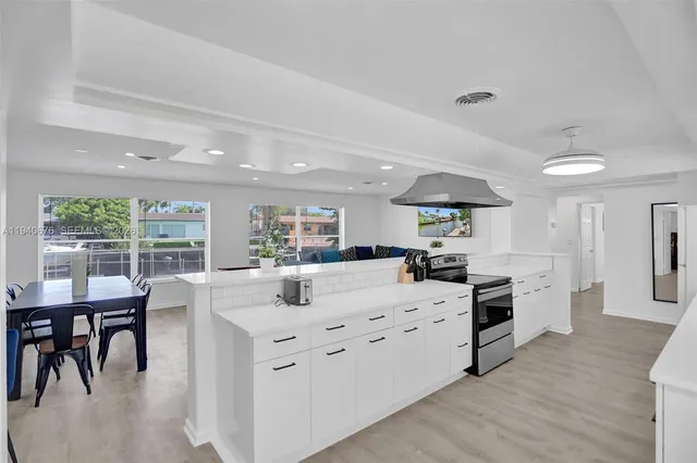 a kitchen with a table chairs stove and cabinets
