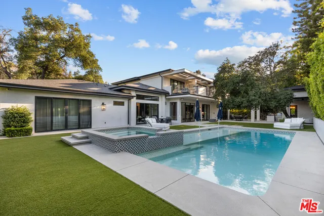 a view of a house with pool table and chairs with wooden fence