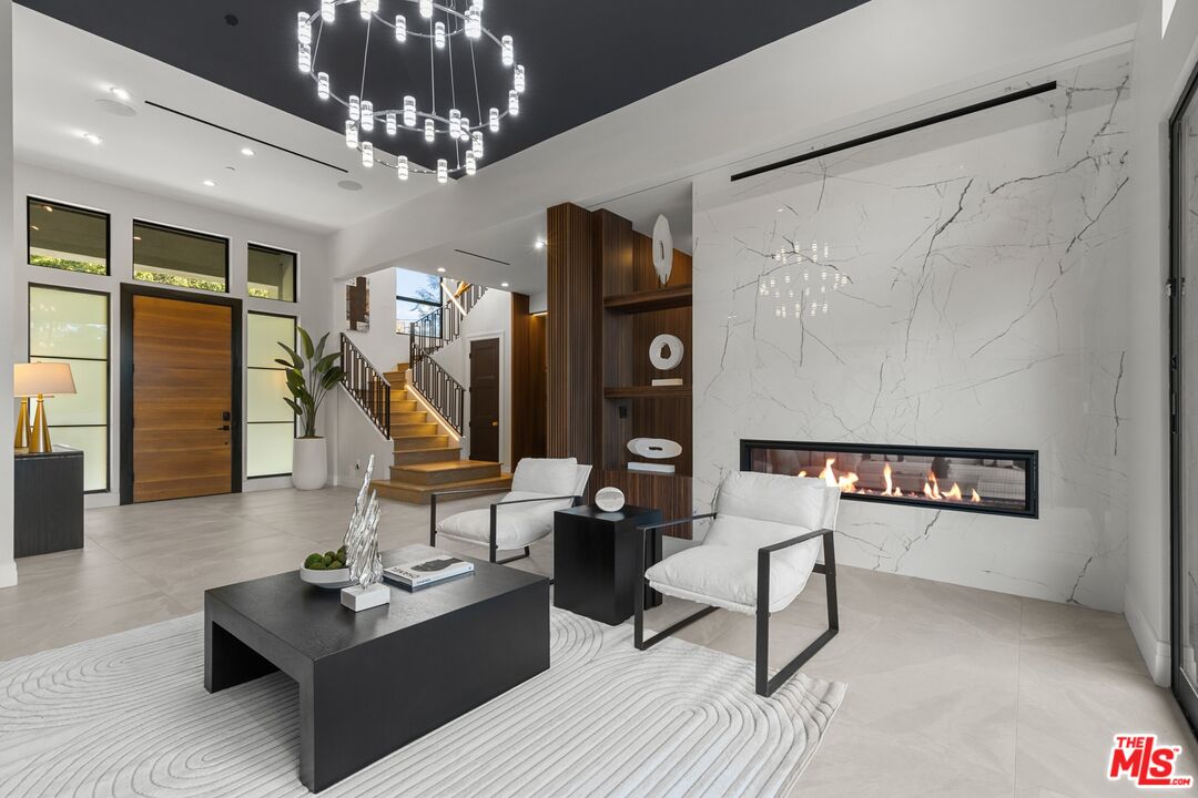 17401 Rancho Street Encino, CA 91316 - Photo 11 of 48 a living room with furniture and a chandelier