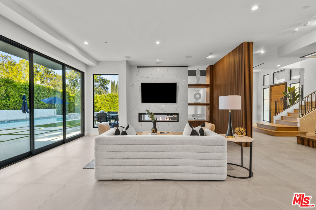 17401 Rancho Street Encino, CA 91316 - Photo 13 of 48 a living room with furniture and a flat screen tv