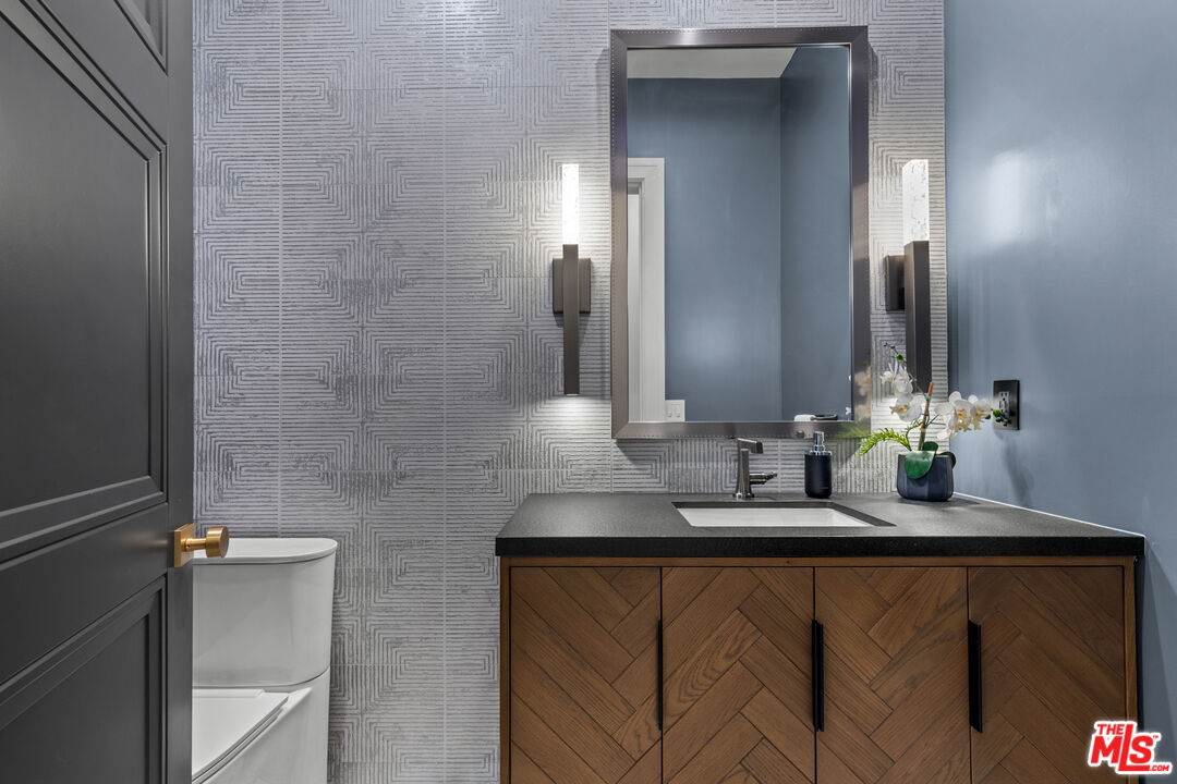 17401 Rancho Street Encino, CA 91316 - Photo 15 of 48 a bathroom with a sink and a mirror